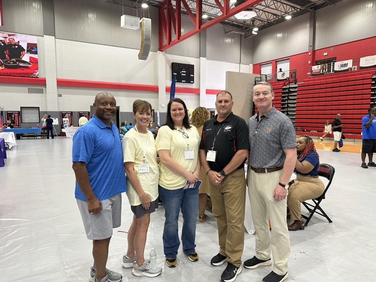 five adults standing 