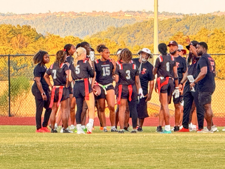 Sunset on a field with players and coaches