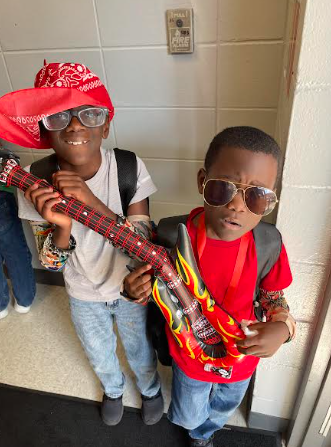2 boys holding guitar
