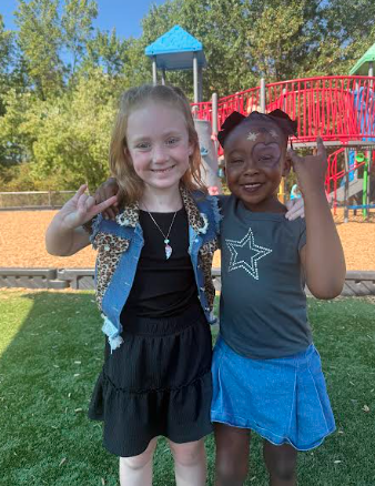 2 girls giving rock in roll hands