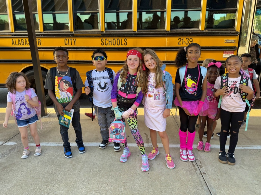 kids standing in front of bus