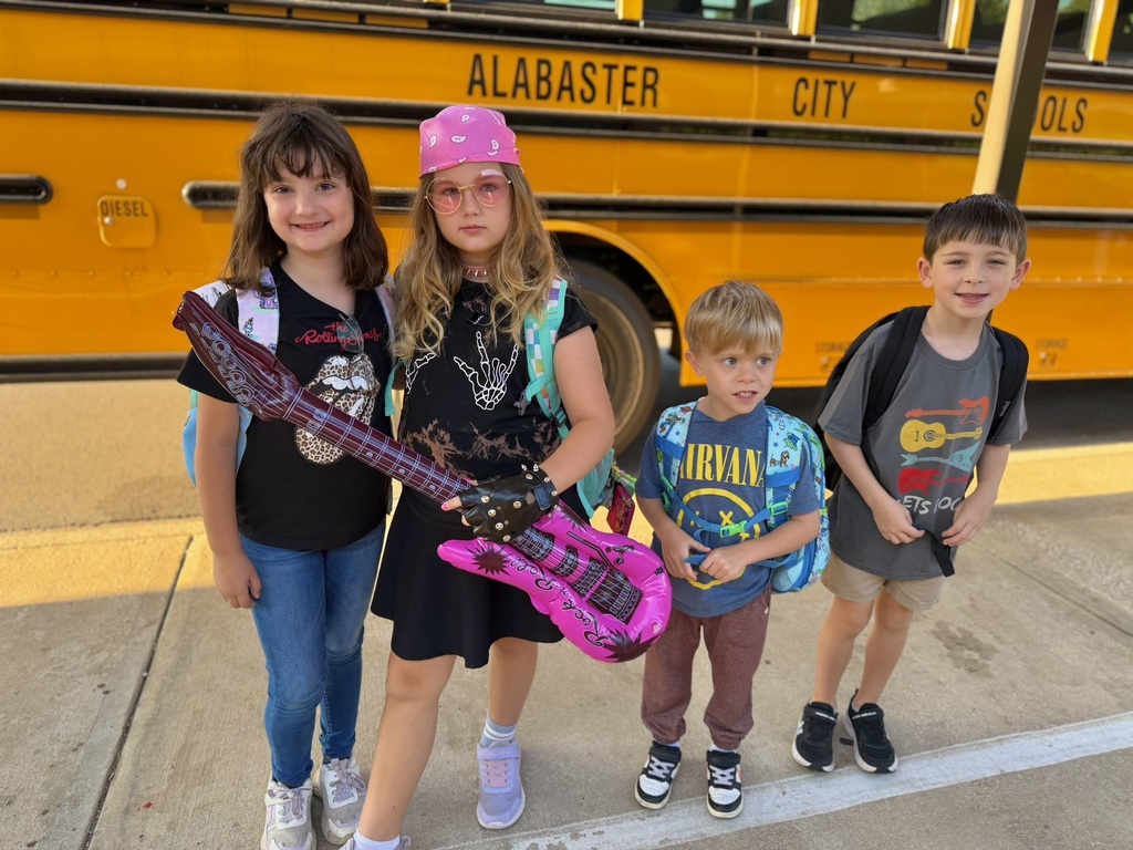 kids standing in front of bus