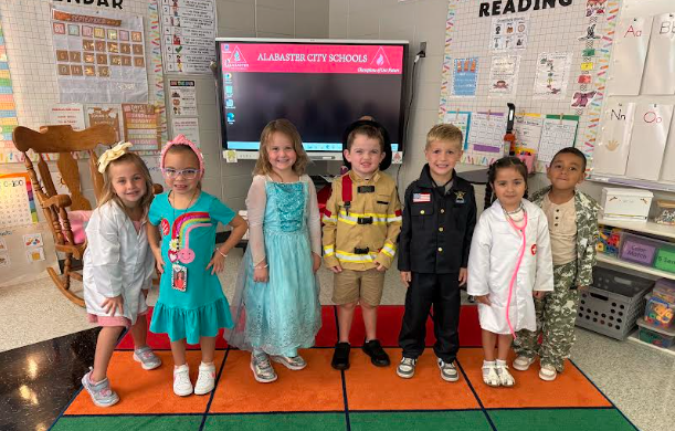 kids standing in classroom dressed up