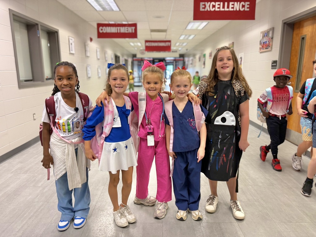 girls standing in hallway dressed up