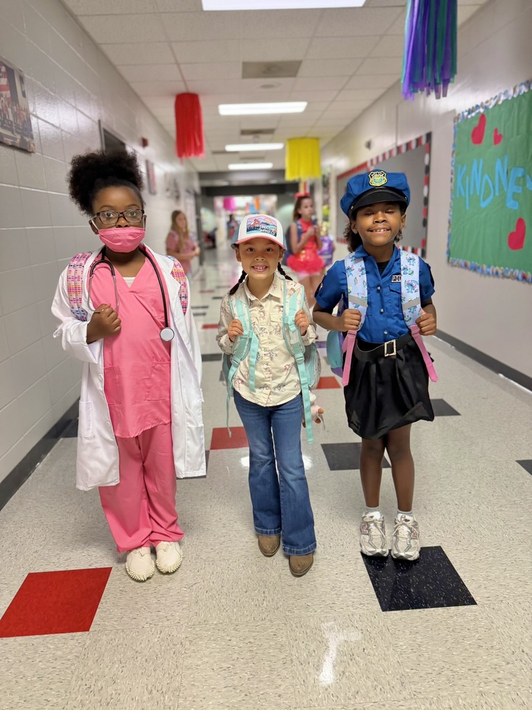3 girls standing in hallway dressed up