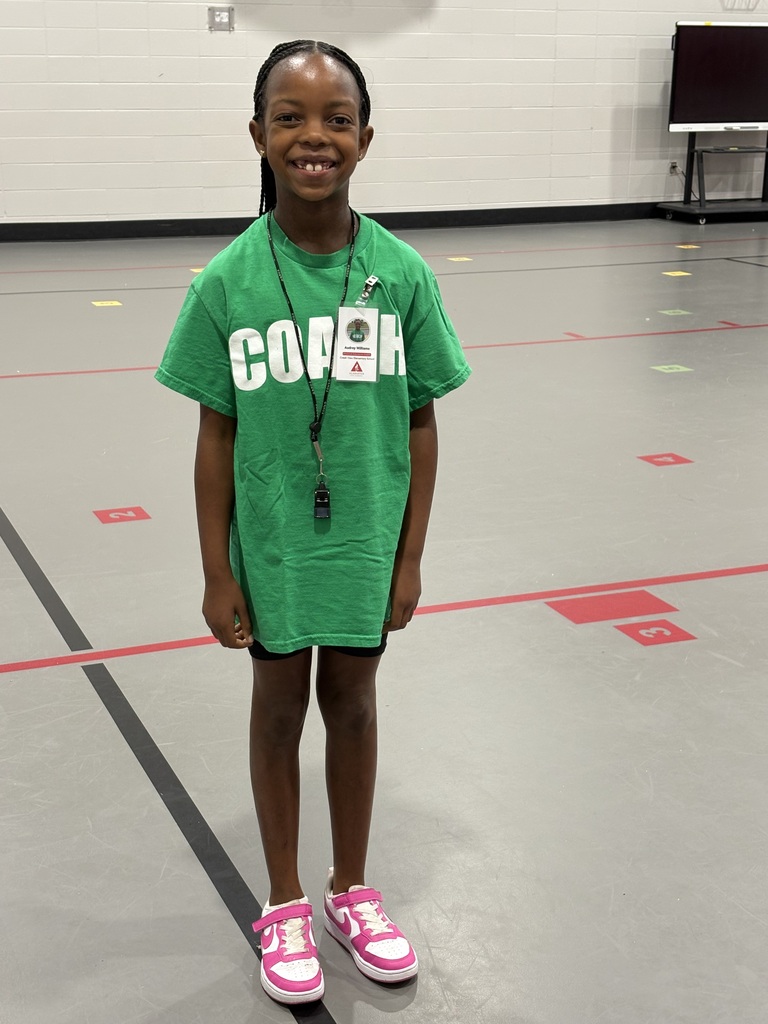 little girl standing in gym dressed as PE coach