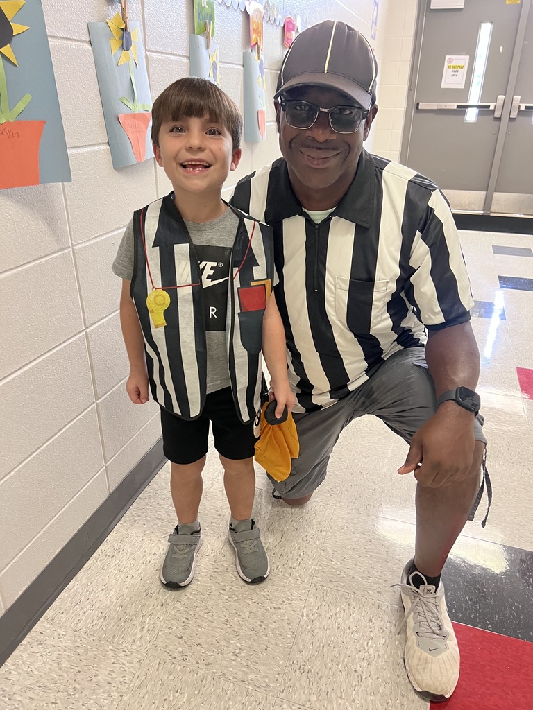 teacher with little boy dressed up as referees