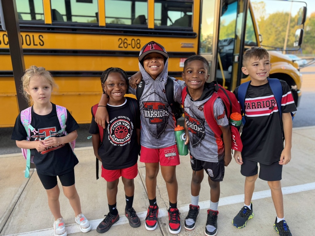 kids standing in front of bus