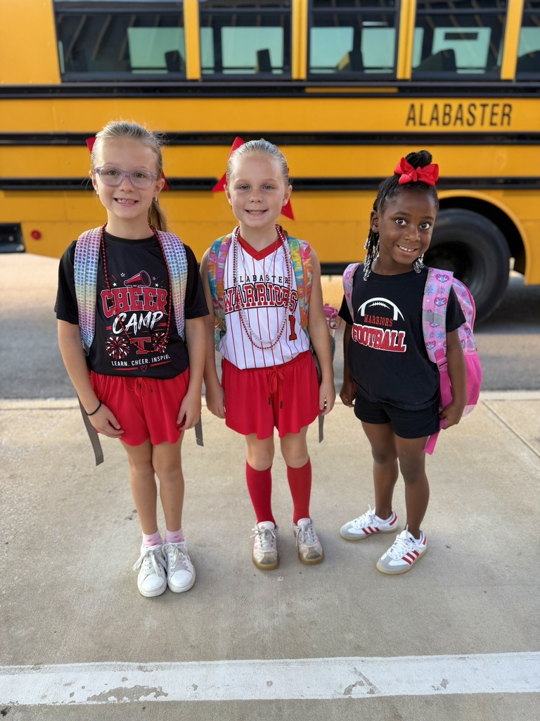 3 girls standing in front of bus