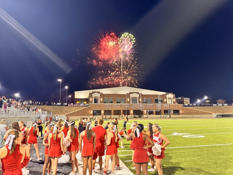 Cheerleaders, watching fireworks above the indoor football practice