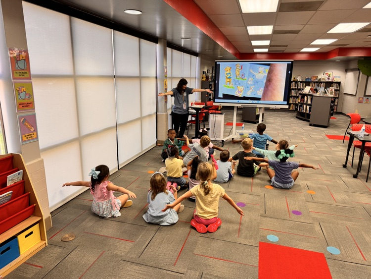 teacher instruction with kindergartners in library