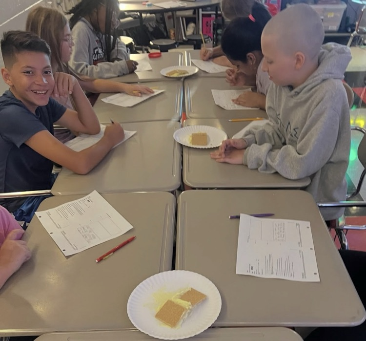 Middle School students engaging in science experiments at a table