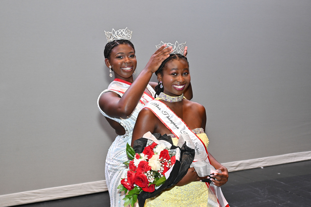 One student is crowning another student at a high school pageant