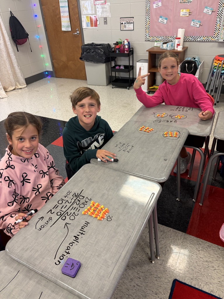 kids doing math on desk with candy corn