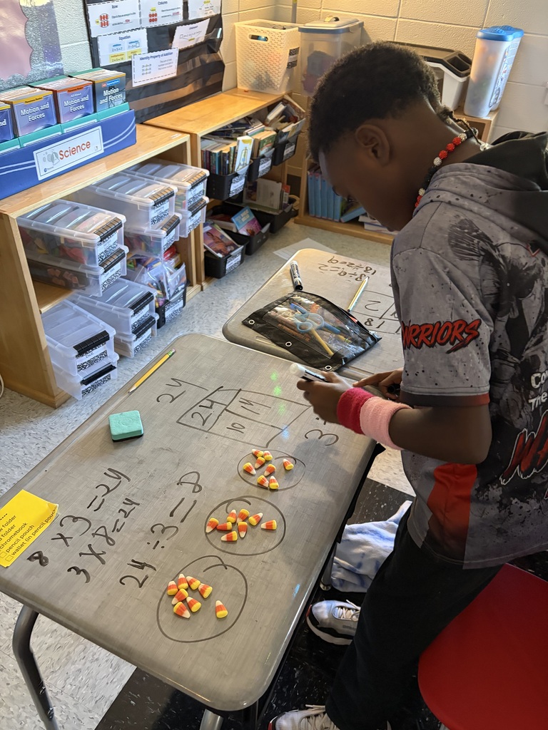 boy doing math on desk with candy corn