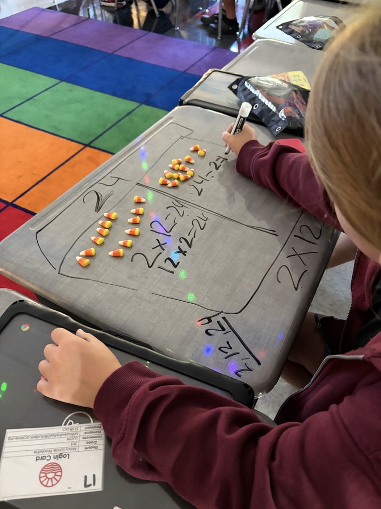 student doing math on desk with candy corn