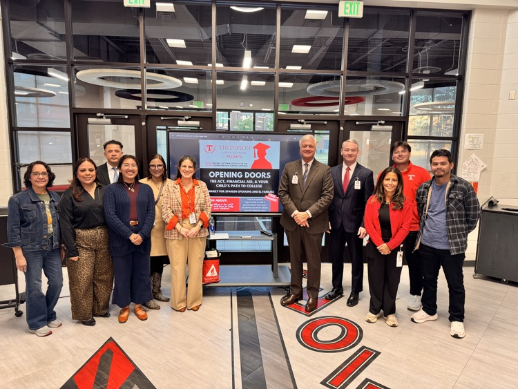 large group of people in front of computer panel