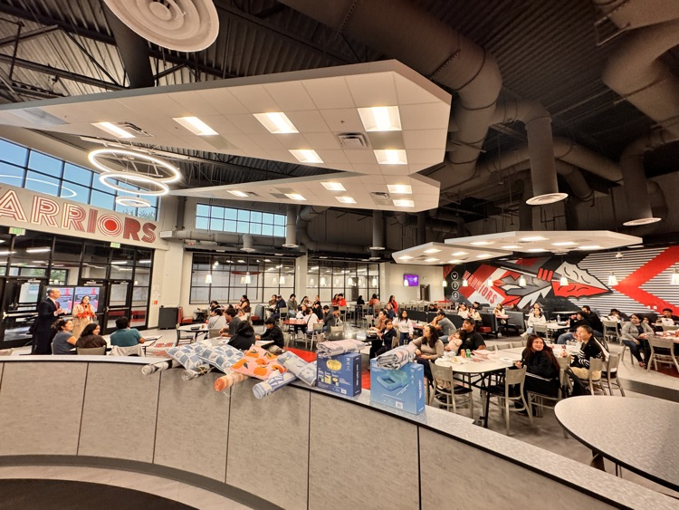 Wide angle shot of a school cafeteria filled with people