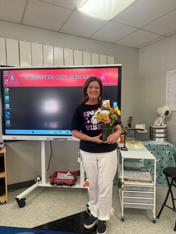Mrs. McCarver holding flowers