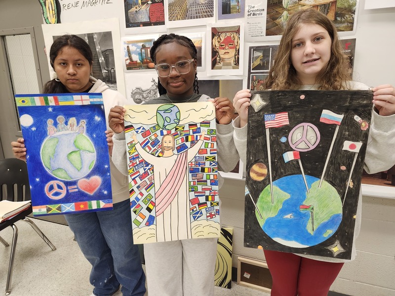 students holding art
