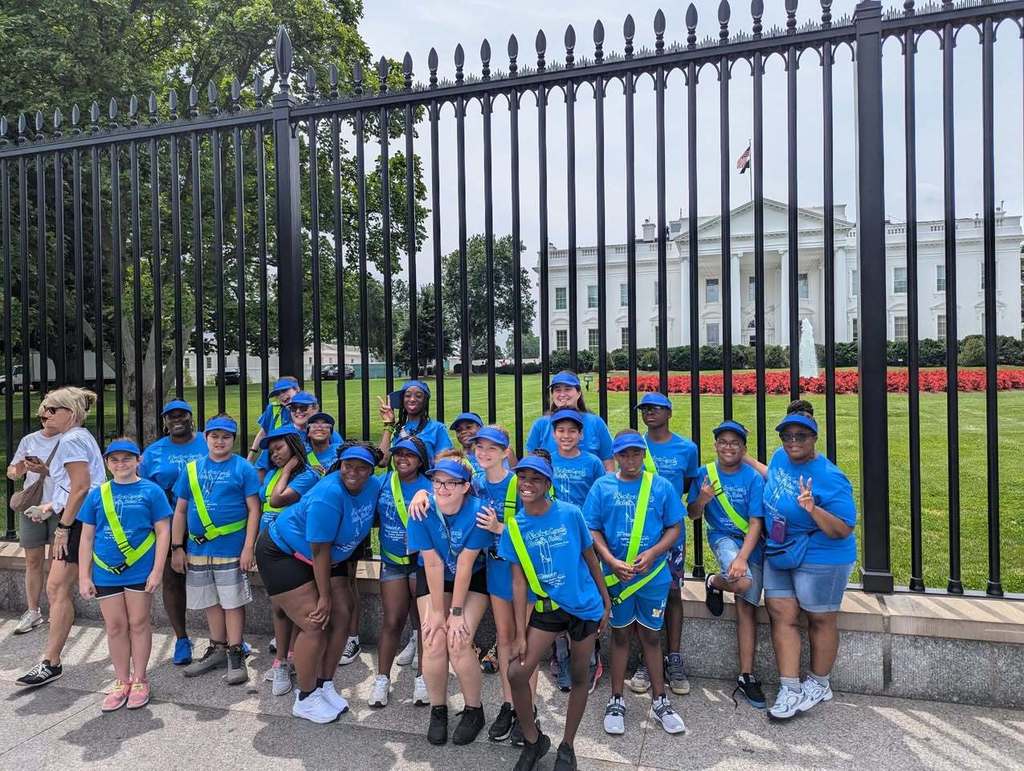 students in club uniforms posing in front of the White House