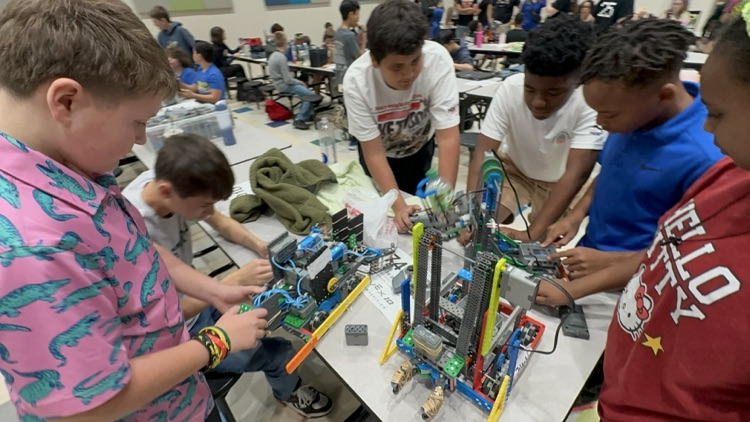 Our young engineers fine-tuning their bots — teamwork in action!