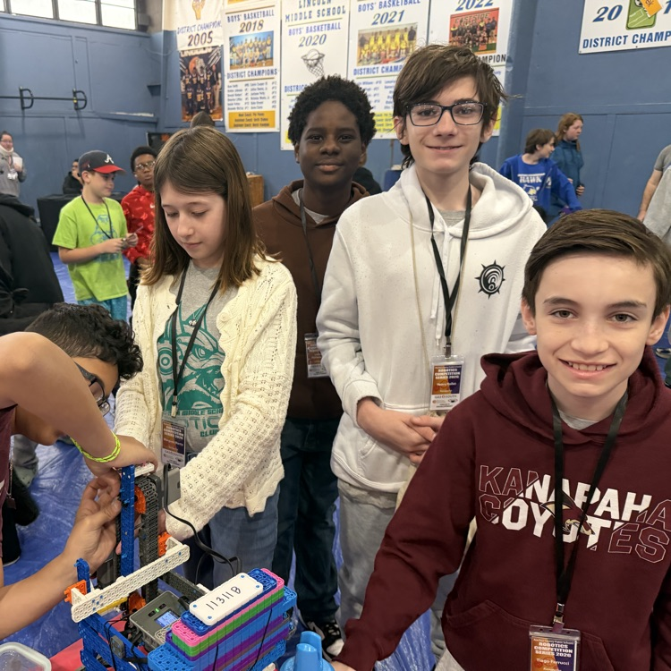 students pictures with a robot built by themselves  