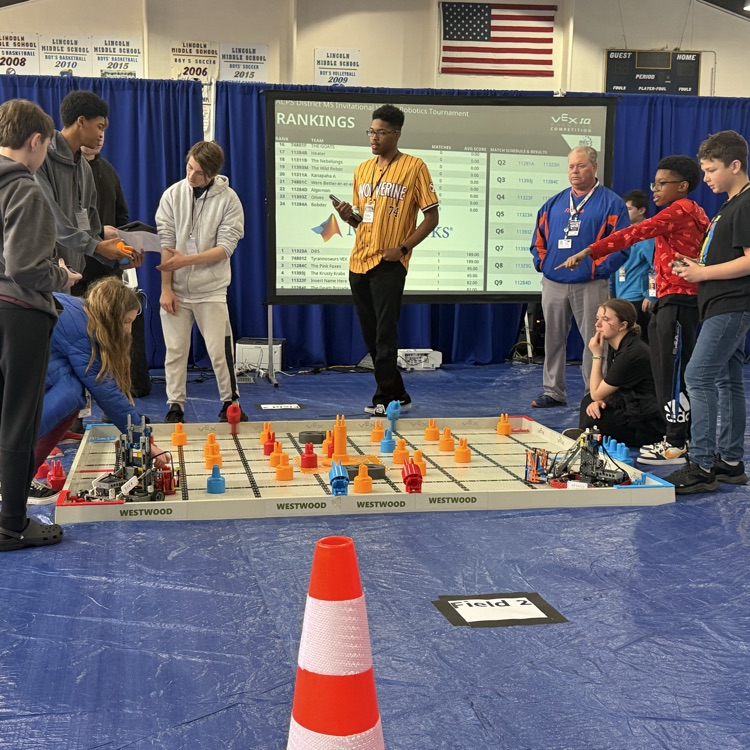 students pictures with a robot built by themselves  