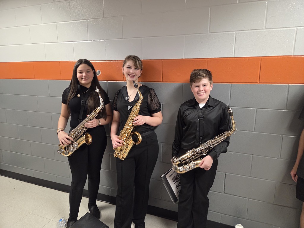 3 saxophone players waiting to perform their ensemble