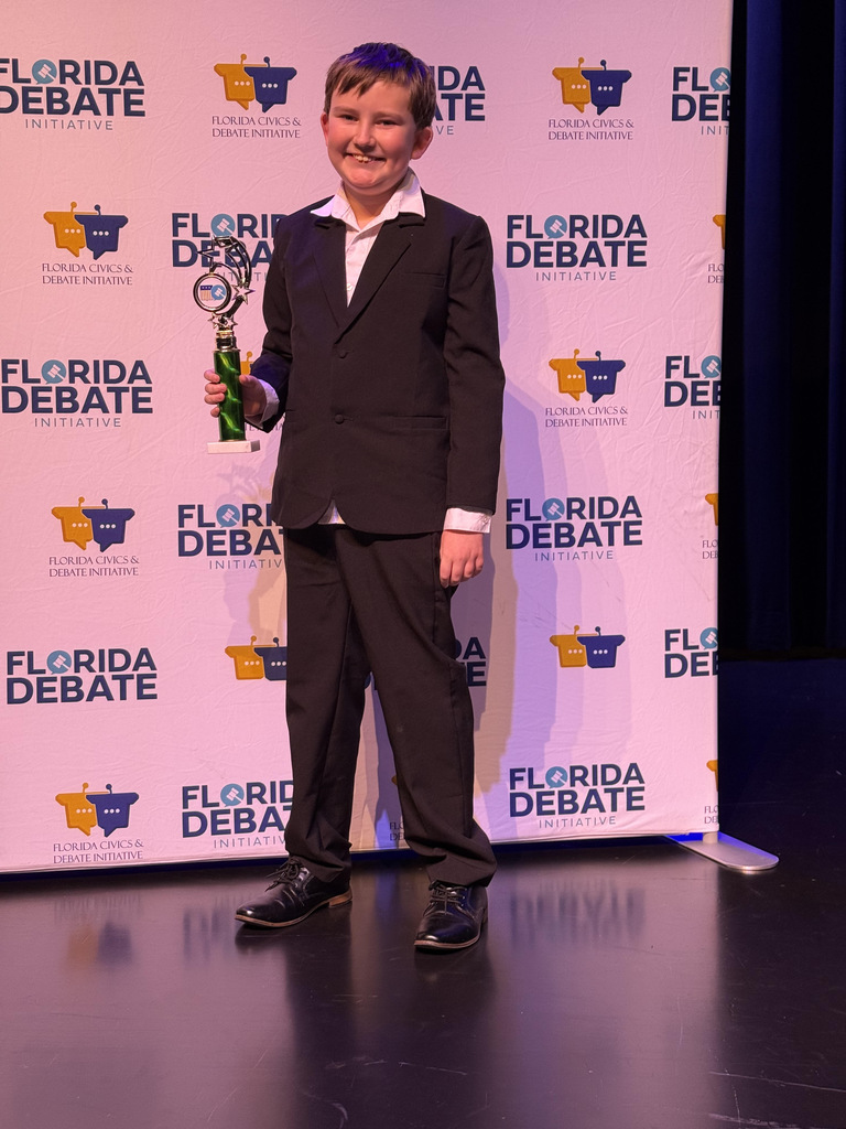 Student with trophy at competition