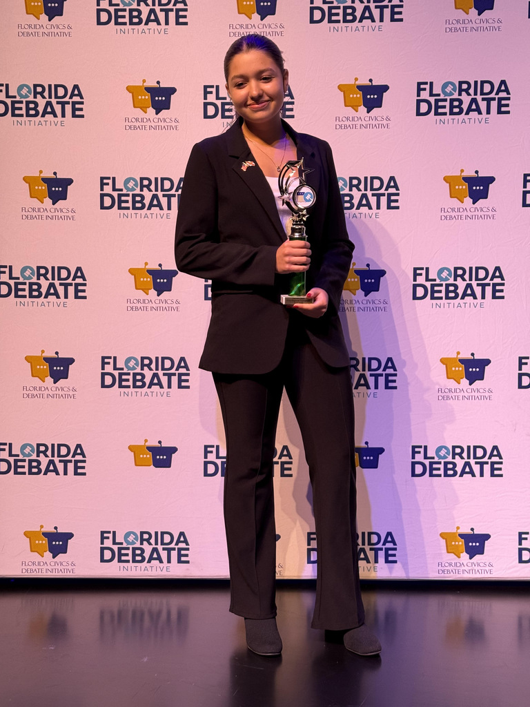 Student with trophy at competition