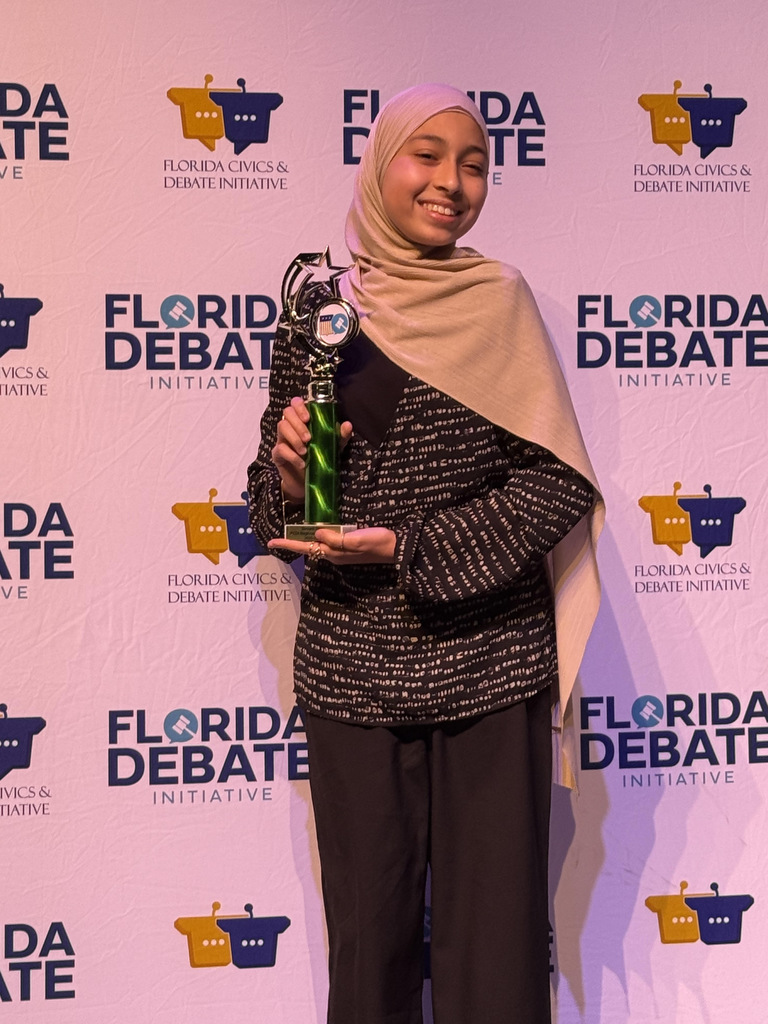 Student with trophy at competition