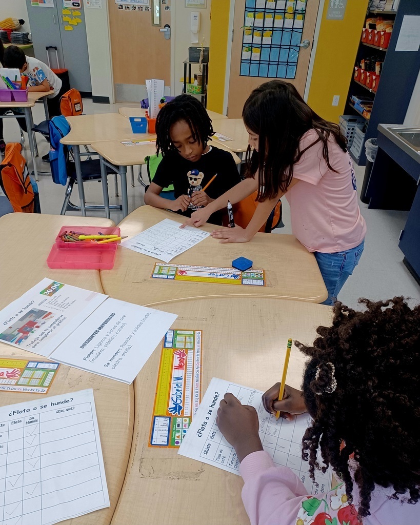 three students working at a desk