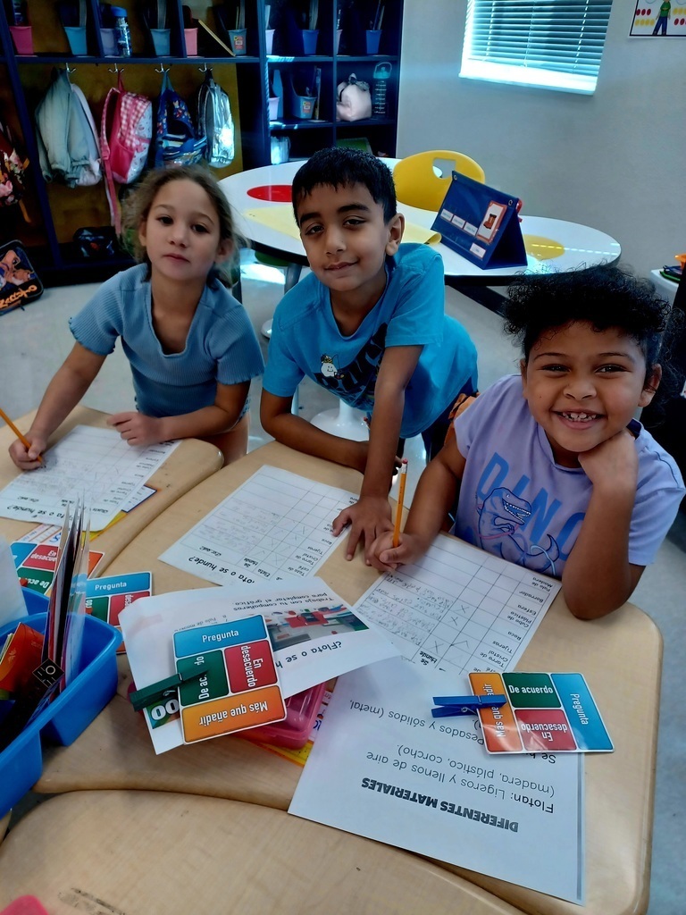 three students working at a desk