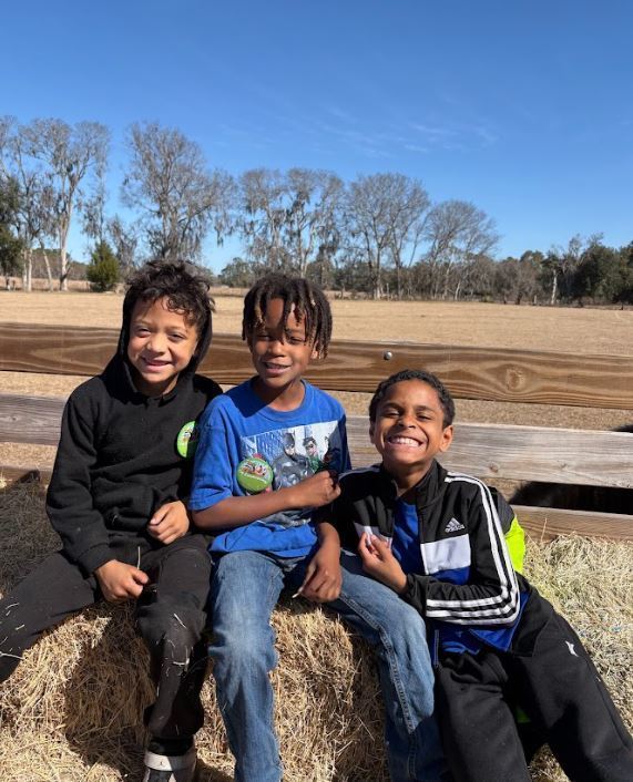 three boys on a hayride