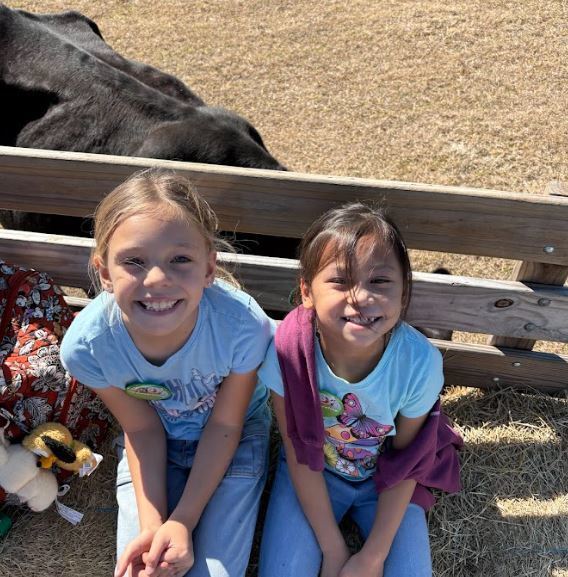 two girls on a hayride