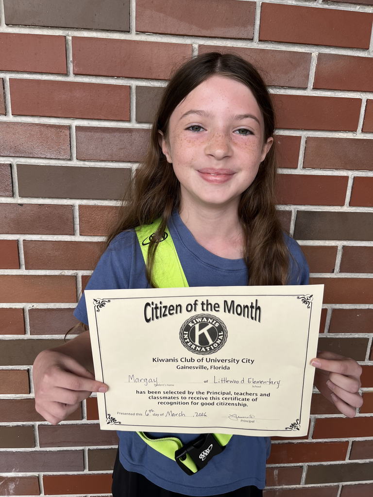 Photo of Margay holding up a Citizen of the Month Certificate