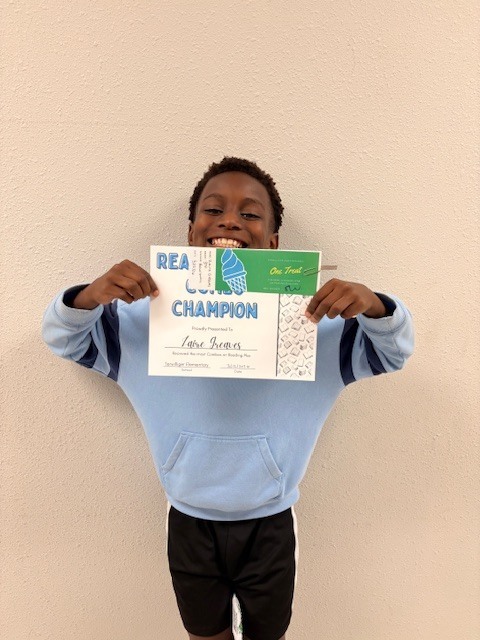 student in front of a door with a certificate