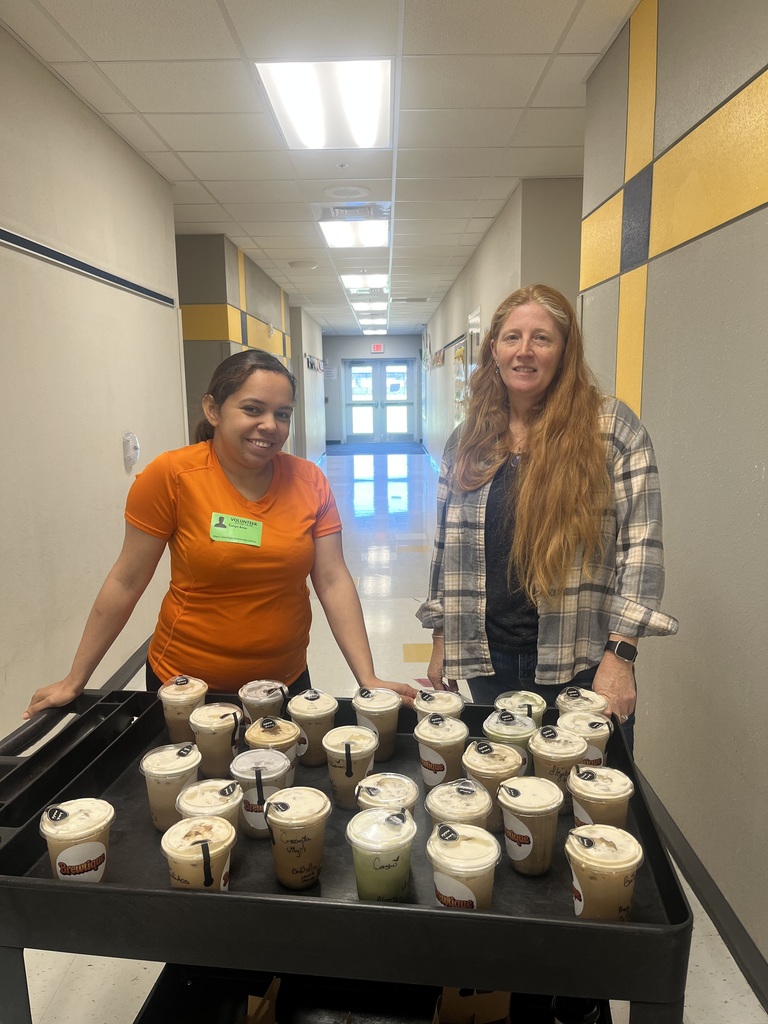 two women pushing a cart full of coffees 