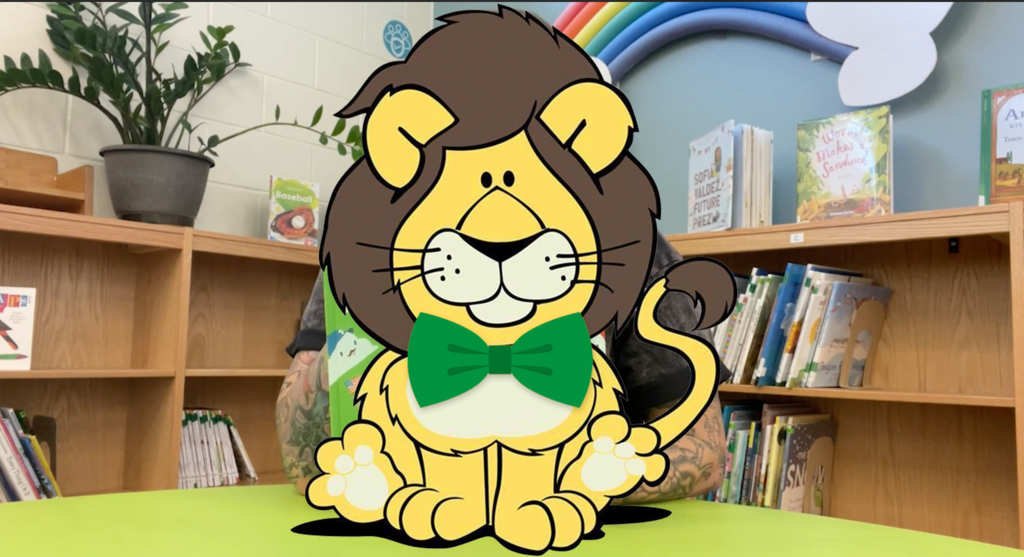 A mystery photo with Lionel the lion blocking who our mystery reader is 