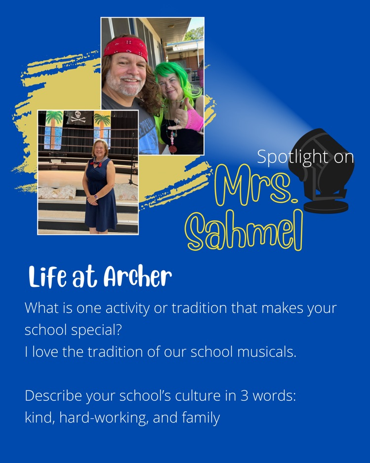 Mrs. Sahmel standing in front of musical set and dressed up for music in our school week