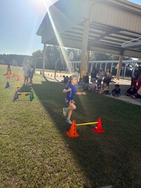 student running to cones
