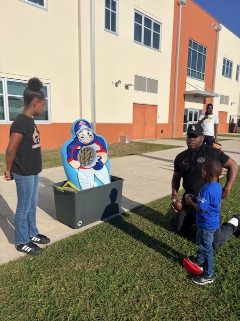 student throwing a basketball to a target