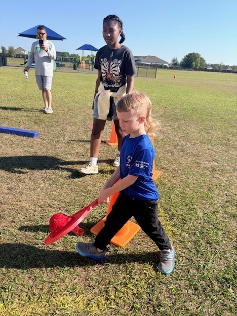 student balancing a red ball