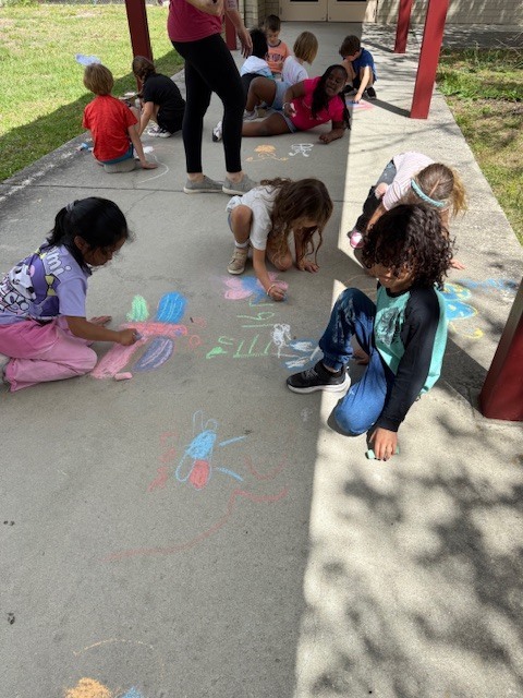 Friday Fun! Ms. Cecere's class enjoyed the sunshine with a picnic lunch bunch while Ms. Rucker's Kindergarten drew sidewalk chalk butterfly predictions based on their Science lesson.