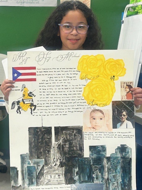 student holding a poster project