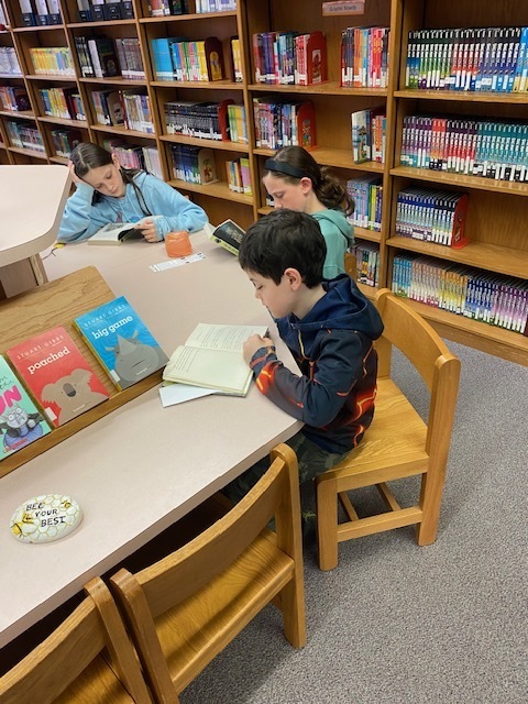 Students reading at a table.