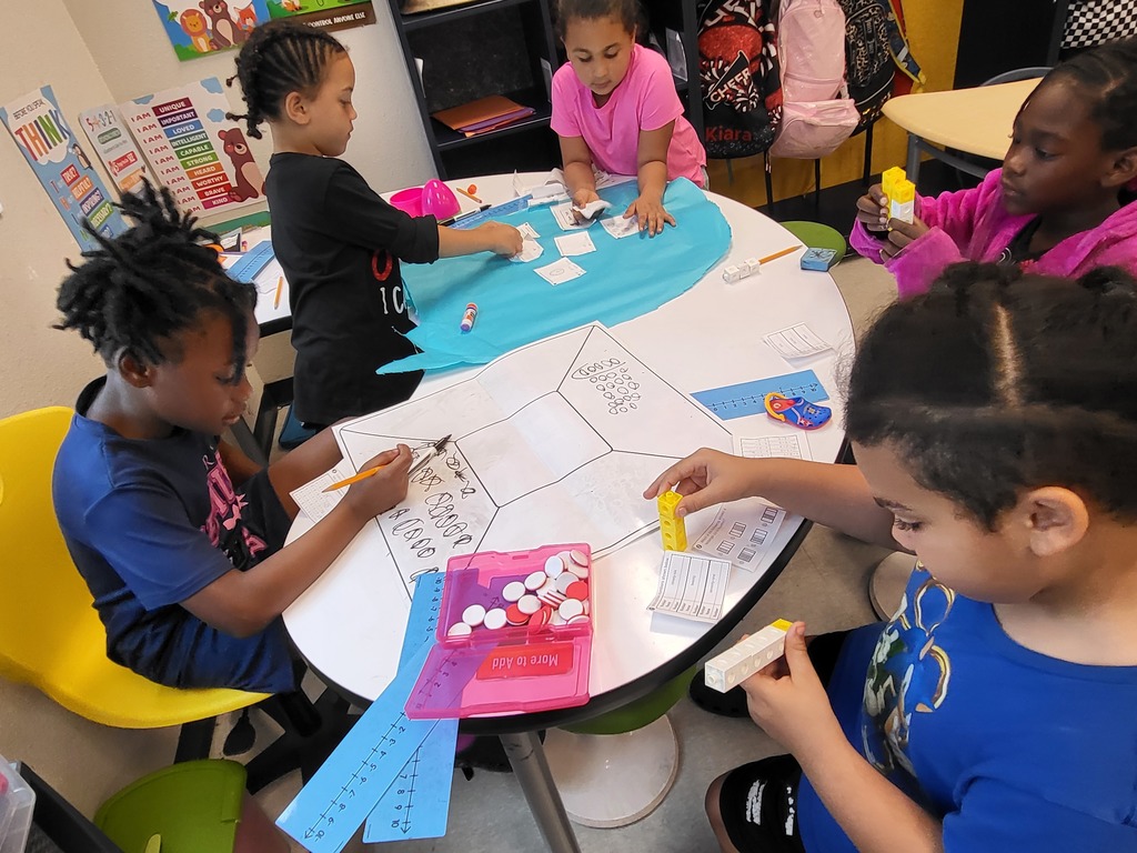 students at a table solving math problems