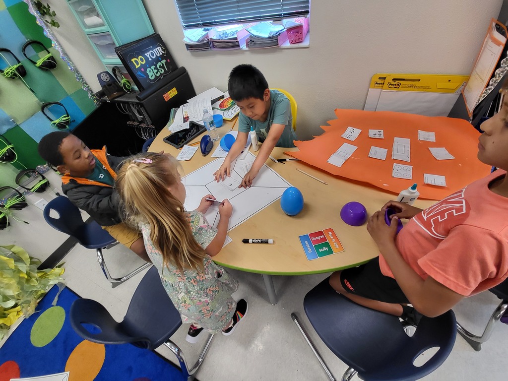 students working at a table to solve math problems