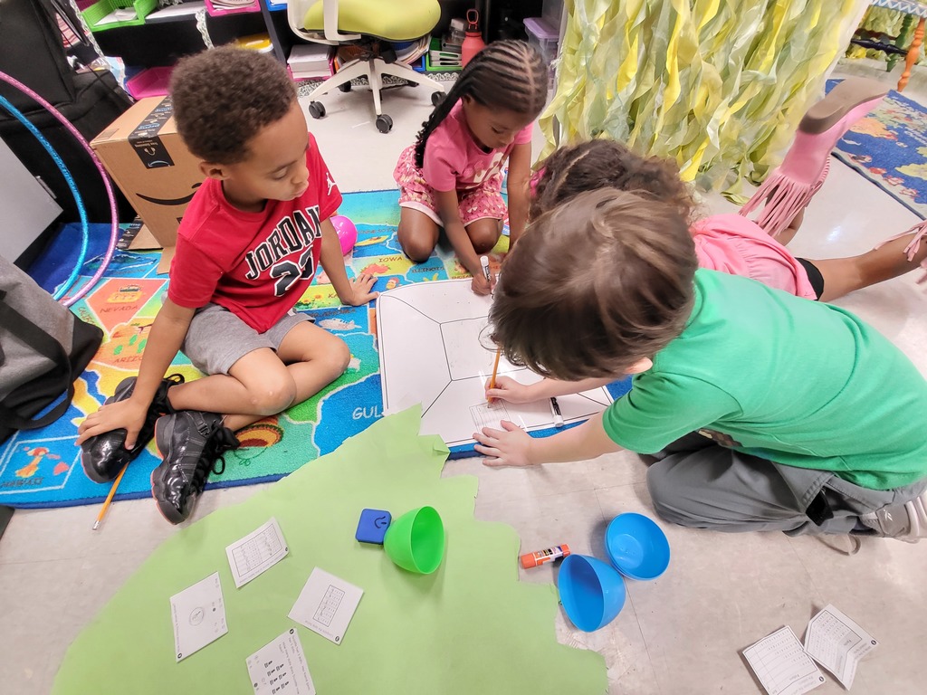 students working on the floor to solve math problems